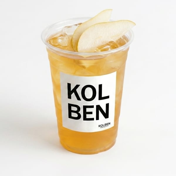 Iced tea with pear slices in a clear plastic cup with a "KOLBEN" label.